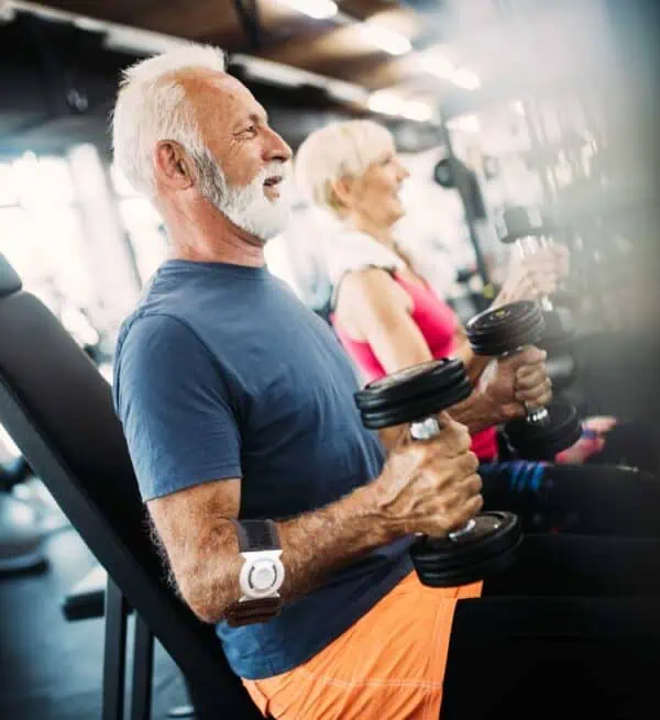 older man lifting weight wearing Bullseye Brace elbow brace